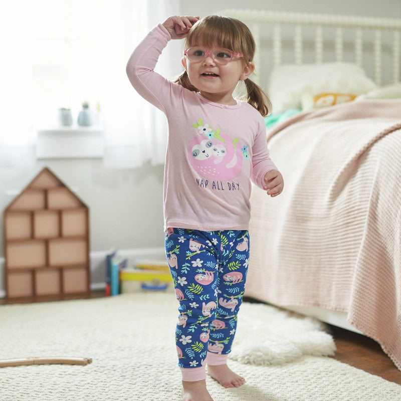 Toddler girl with glasses playing in her room