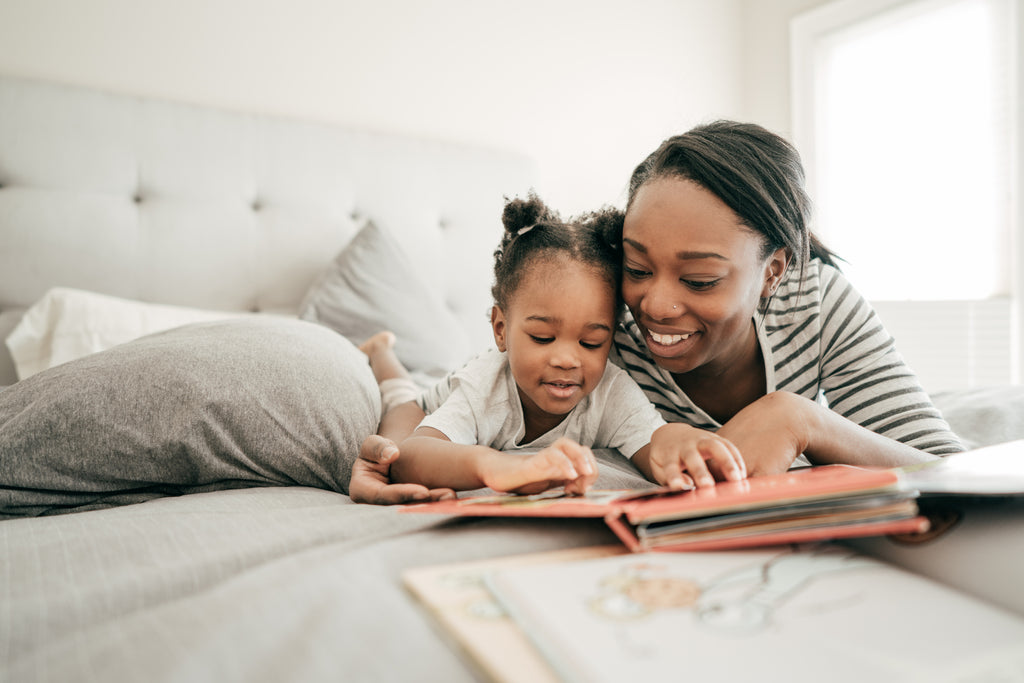 mother reading to daughter before kid’s bedtime