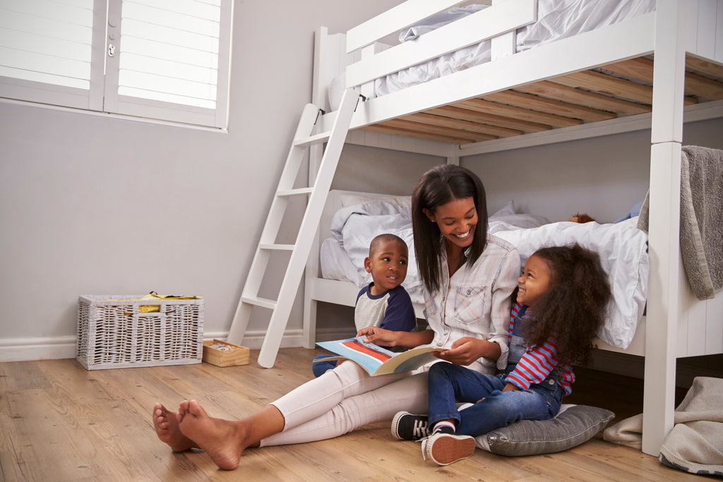 mother reading to her kids in kid's room with bunk beds