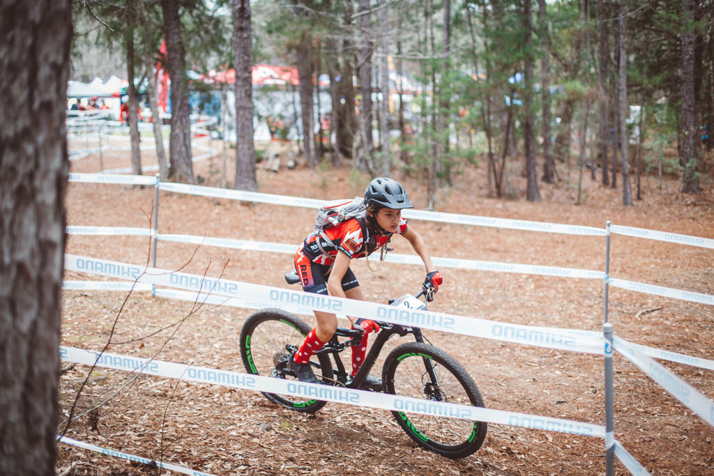 NICA mountain bike racer on course.