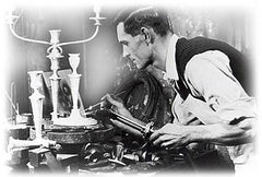 A silversmith repairing a candlestick