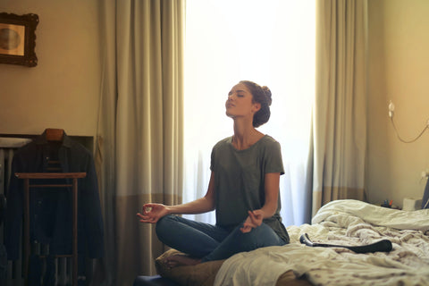 Woman meditates inside room