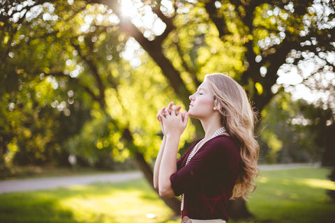 Woman praying in the park