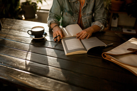 Woman writing on her journal