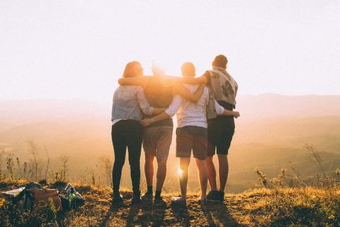 Four friends embracing and showing healthy social support