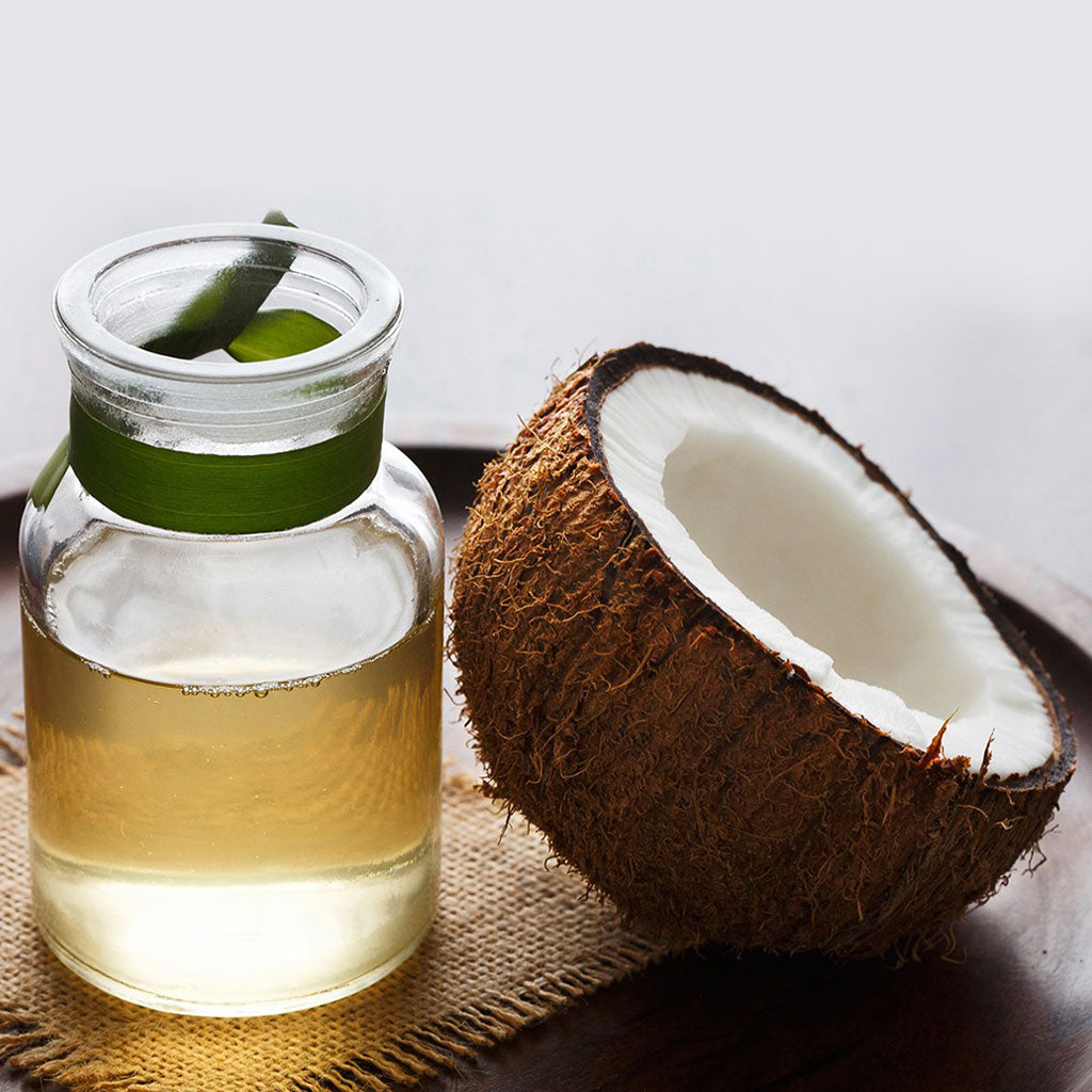 Coconut Oil in Jar with a Coconut in half