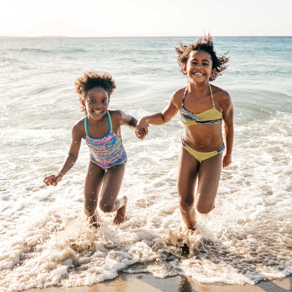 Two Girls Running On Beach