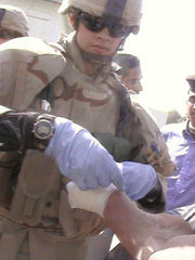Sgt. Witzke aiding an injured Iraqi Policeman