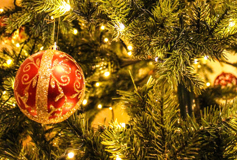 the image shows a close up of a bauble on a Christmas tree