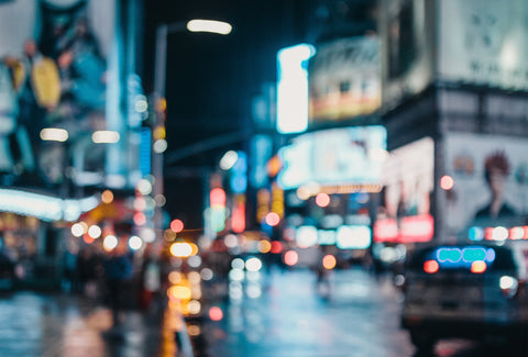 the image shows a blurred vision view of a busy city at night