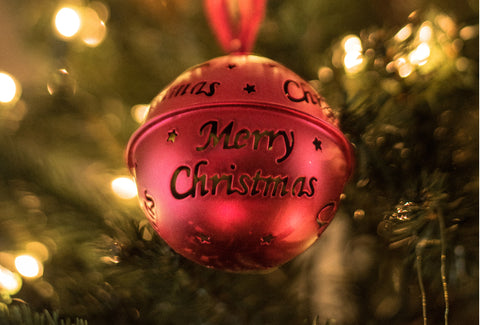 the image shows a close up of a bauble on a christmas tree