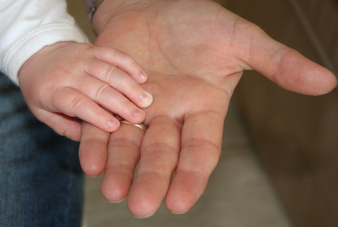 the image shows a child holding hands with an adult