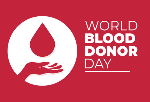 The image shows a picture of a hand with a large drop of blood above it, along with the words – World Blood Donor Day