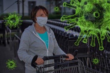A woman pushing a supermarket trolley with a large, green bug by her side