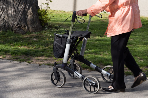 A woman walking with a rollator