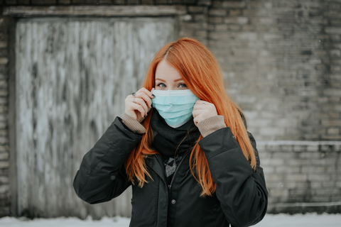 A woman wearing a disposable mask