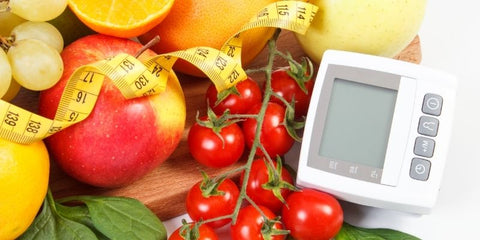 the image shows a blood pressure test with some healthy food and a tape measure