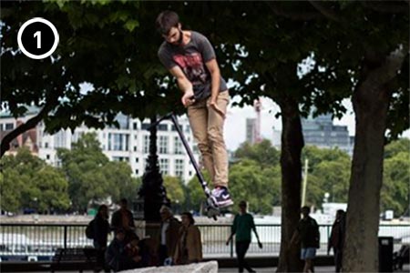 Guy completing barspin freestyle scooter trick 