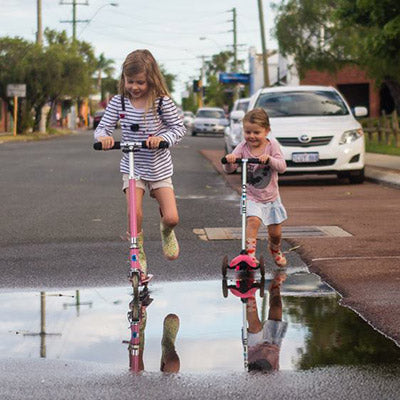 Kids having fun on their 3-wheeler Micro Scooters 