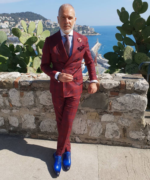 Suited Traveller wearing Thomas Bird custom blue wholecuts with a red prince of Wales suit
