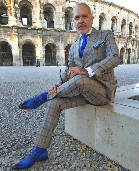 Suited Traveller wearing Thomas Bird custom blue wholecuts with a grey/blue windowpane suit
