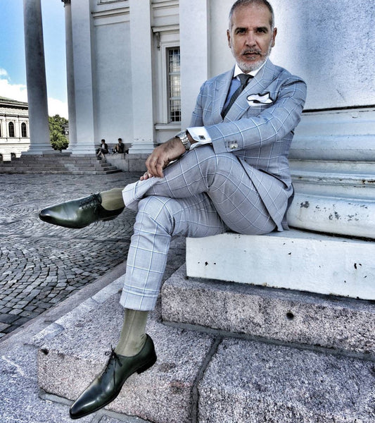 Suited Traveller wearing Thomas Bird green wholecuts with a pale blue windowpane suit