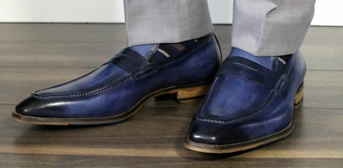 Blue penny loafers with light grey suit