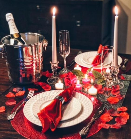 Candlelit dinner with champagne and rose petals