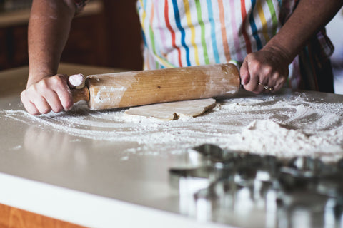Person rolling dough with rolling pin