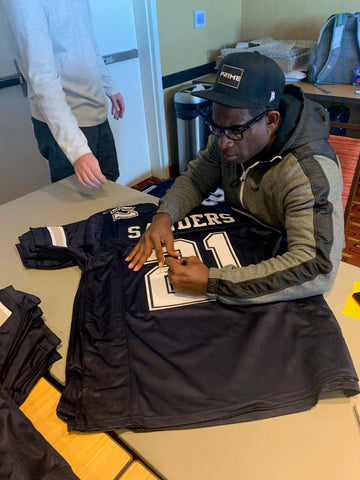 Deion Sanders signing custom jerseys