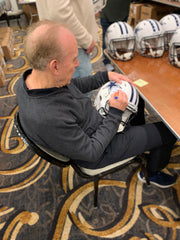 Roger Staubach signing Flat White helmet