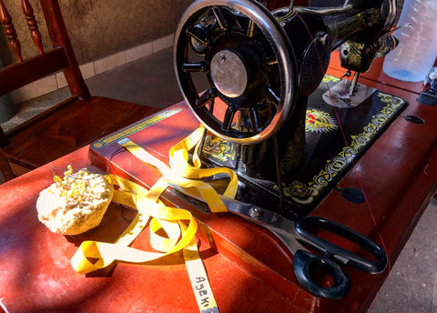 moon and lola seamstress with manual sowing machine in togo africa