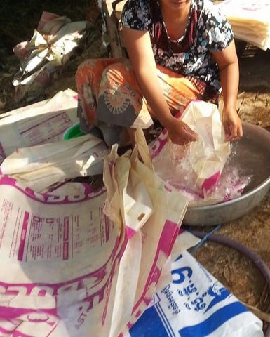 Cambodian woman wash upcycled cement and rice sack