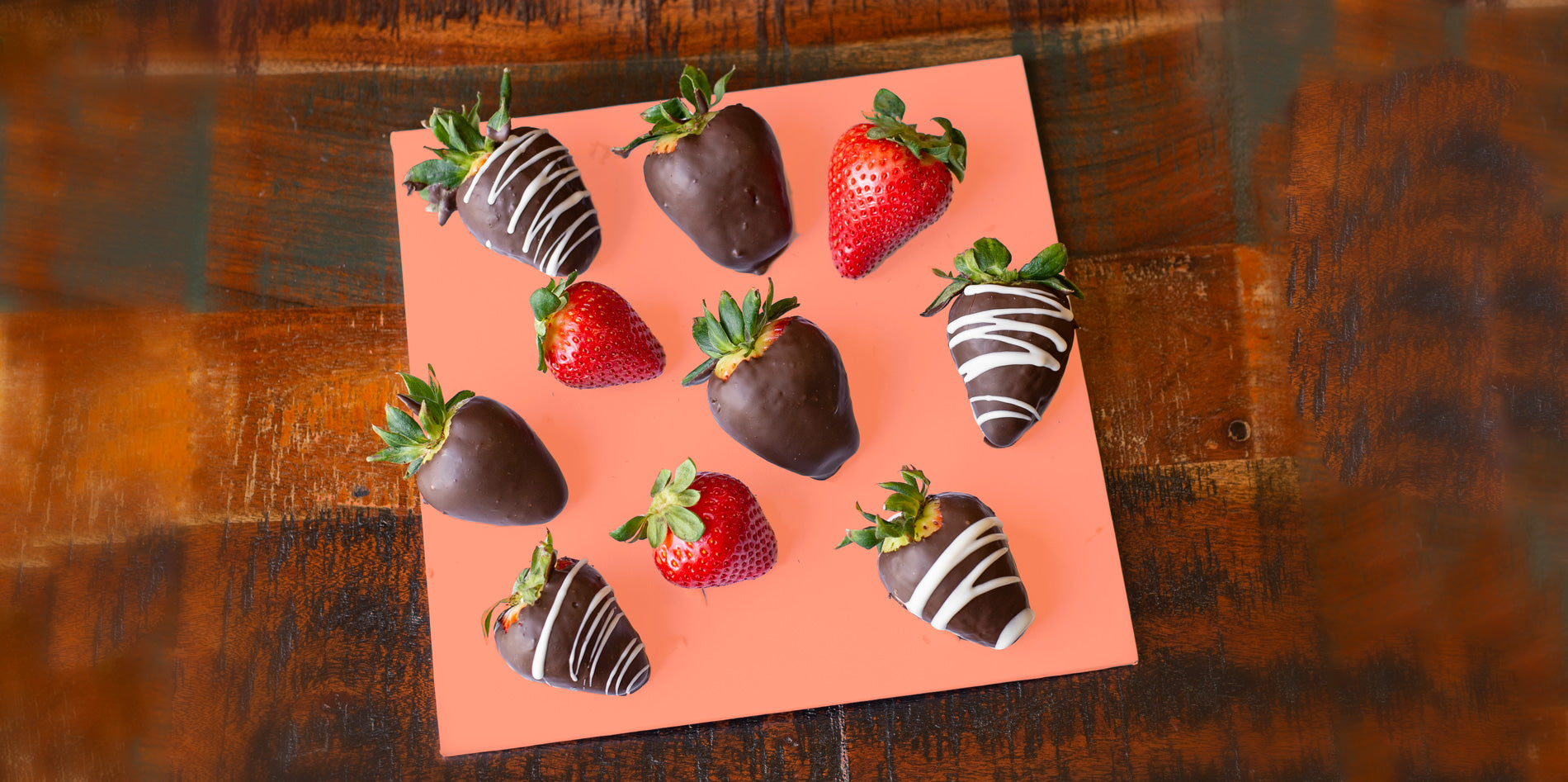 chocolate strawberries on orange board