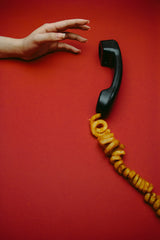 Telephone and online therapy: a hand reaches for a telephone