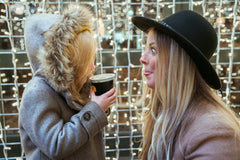 Happy woman pulling silly faces at child