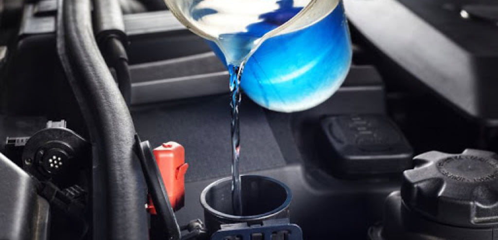 Blue antifreeze pouring in engine cooling system.