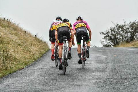 3 cyclists up a hill
