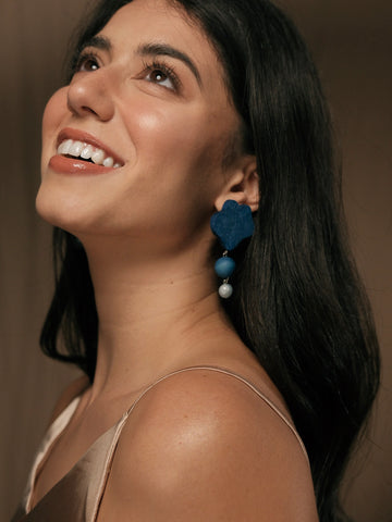 Emma wearing earrings in classic blue