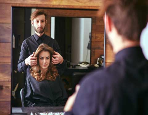 hairdresser doing a haircut to client