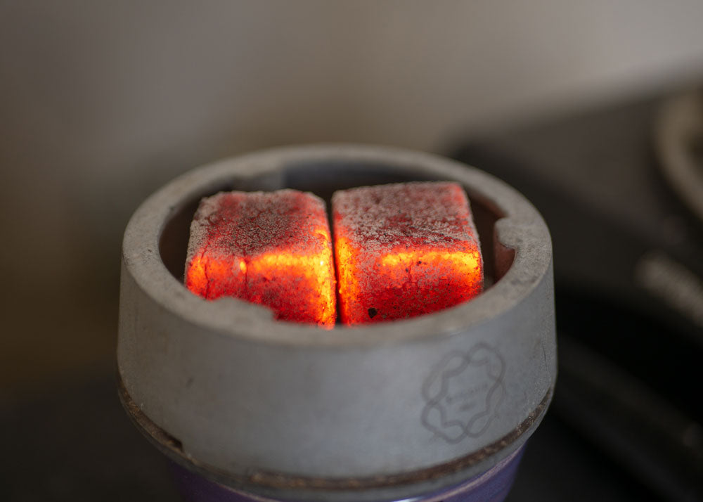 Red-hot coconut hookah coals in Kaloud Lotus
