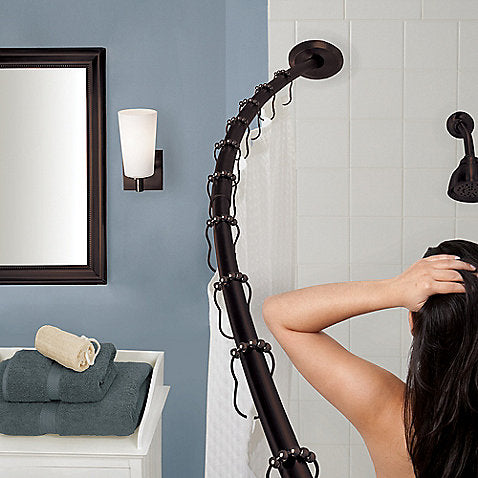 small blue bathroom with white shower, rubbed bronze curved shower rod for extra elbow room in the shower!... 5 Steps to Make Your Small Shower Look Bigger Without Remodeling from Bathroom Bliss by Rotator Rod 