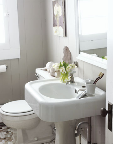 beautiful light gray bathroom with pedestal sink, white-framed mirror & flowers... Bathroom Design Trends: Gorgeous Gray Inspiration