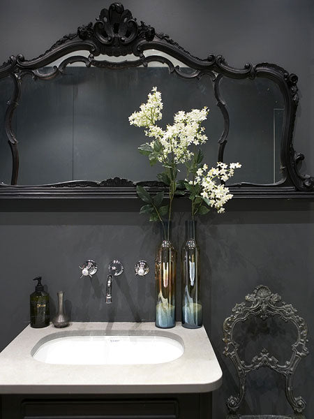 dramatic dark gray bathroom with black framed mirror & white flowers... Bathroom Design Trends: Gorgeous Gray Inspiration
