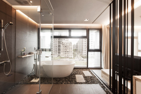 modern zen-inspired bathroom with rock garden, freestanding bathtub, shower, and city views of downtown Taiwan... Beautiful Bathroom Inspiration: Big City Style