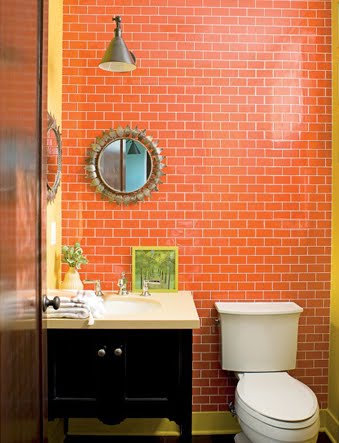 small but sophisticated orange bathroom with orange subway tile... Beautiful Bathroom Inspiration: Orange Bathrooms from The Bathroom Bliss Blog by Rotator Rod, the original curved shower rod that rotates!