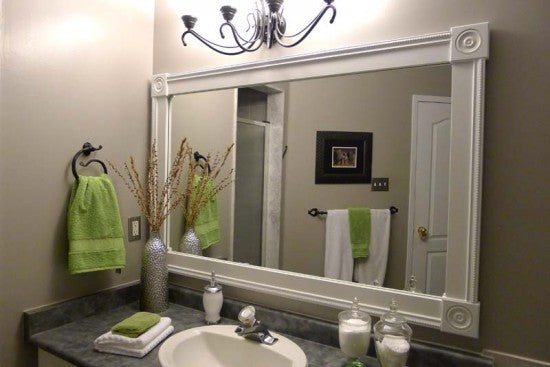 DIY bathroom mirror frame with white molding in gray and green bathroom... Easy Bathroom Updates for a More Luxurious Rental Apartment