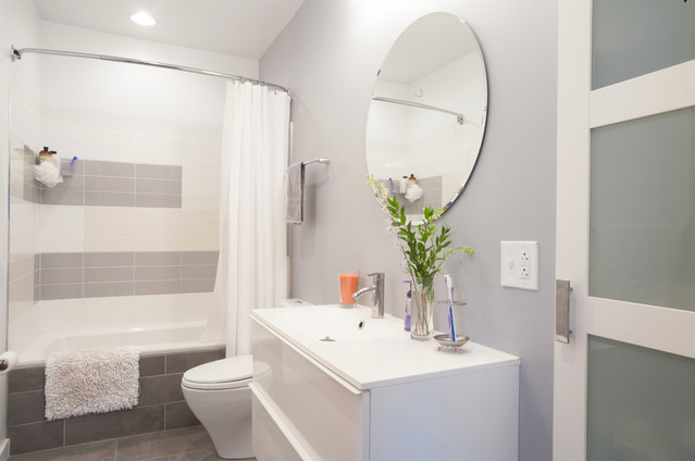 beautiful gray and white bathroom featuring a curved shower rod... Hottest Space-Saving Bathroom Trends for 2015 from The Bathroom Bliss Blog