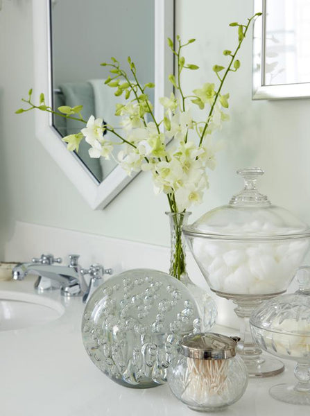 white and gray bathroom vanity with glass jars filled with bathroom essentials... Prepare for Holiday House Guests with a Well Stocked Guest Bathroom from The Bathroom Bliss Blog by Rotator Rod