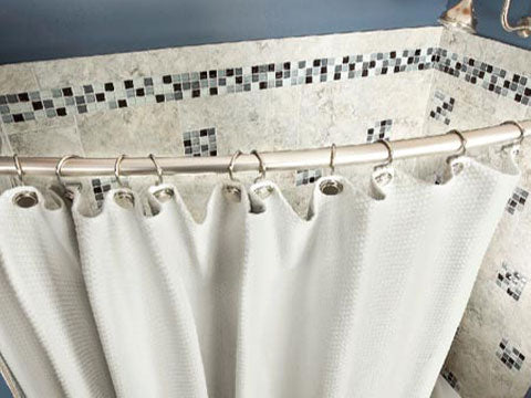 cute white and blue tiled shower with white shower curtain on a curved shower rod... Quick Fix Bathroom Ideas: Expand Shower Space Easily with a Curved Shower Rod from Bathroom Bliss by Rotator Rod